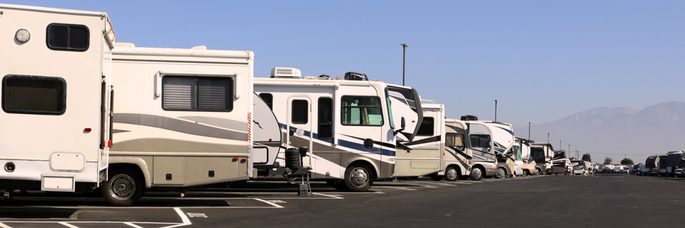 Wide organized aisle between rows of stored recreational vehicles